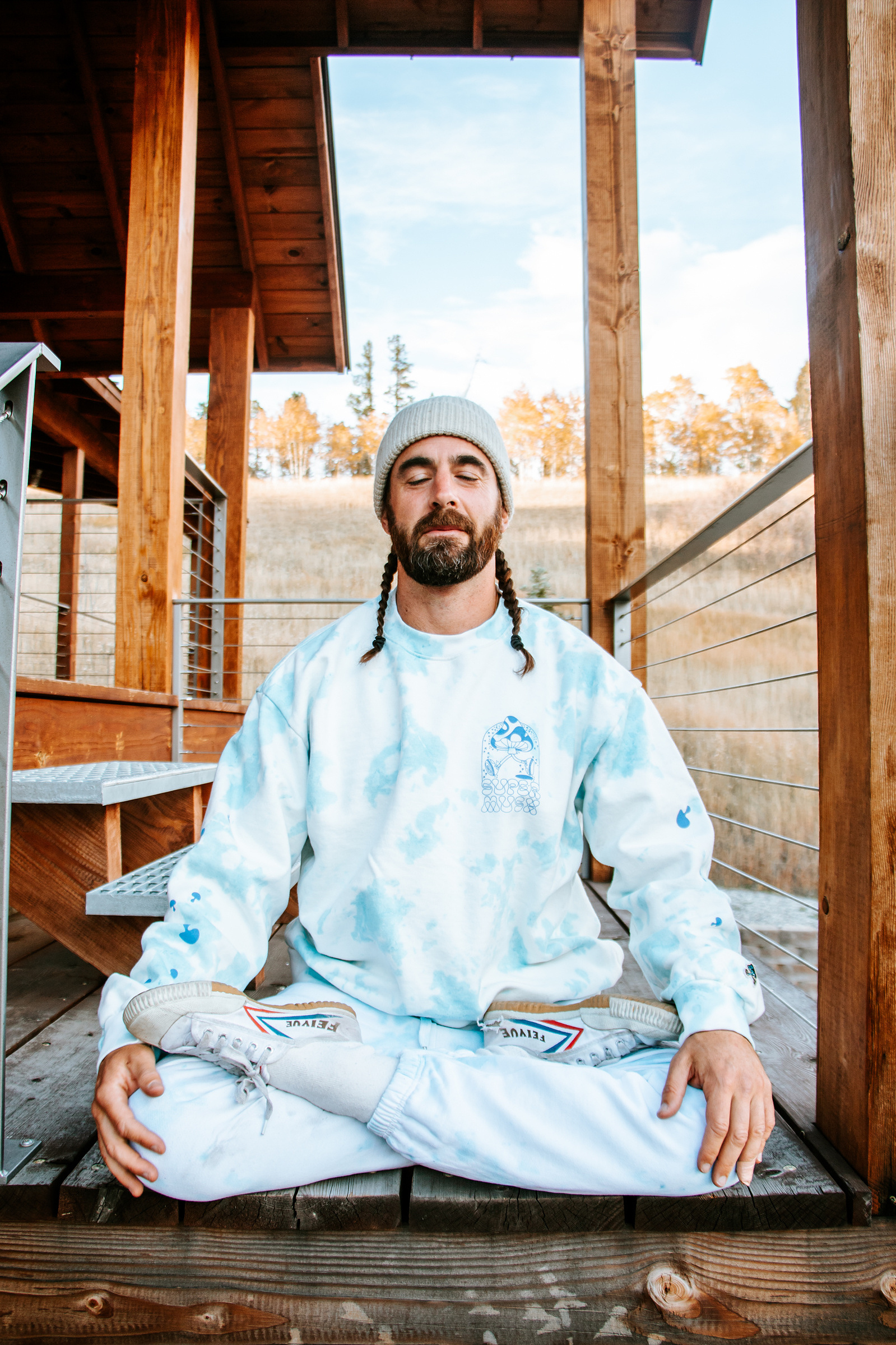 Benjamin Sears does full lotus (Padmasana) on his front porch while wearing sponsored SuperMush merchandise.