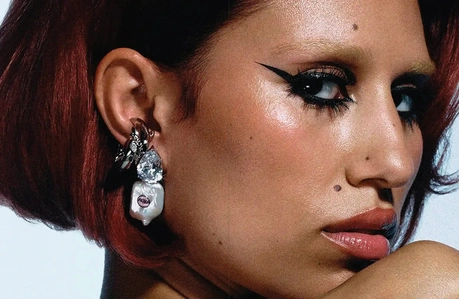 A spread with a close-up photo of Raye looking over her shoulder.