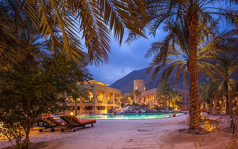 Six Senses Oman at Dusk - As dusk sets over the rugged landscape, Basel Almisshal captures the serene beauty of Six Senses Oman. The resort, illuminated by the soft, fading light of the setting sun, blends harmoniously with the natural surroundings. This 