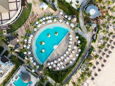 Aerial view of a luxury resort pool in Punta Cana captured by Basel Almisshal. Specializing in high-end hospitality photography that showcases design, scale, and the allure of premium resort experiences.