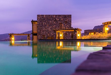 Alila Jabal Akhdar Luxury Hotel - Basel Almisshal captures the tranquil beauty of Alila Jabal Akhdar&amp;amp;amp;amp;amp;amp;amp;amp;amp;amp;amp;amp;amp;#x27;s stone architecture and serene infinity pool. Bathed in the soft, clear dusk light, this peaceful scene epitomizes calm and luxury amidst breathtaking su