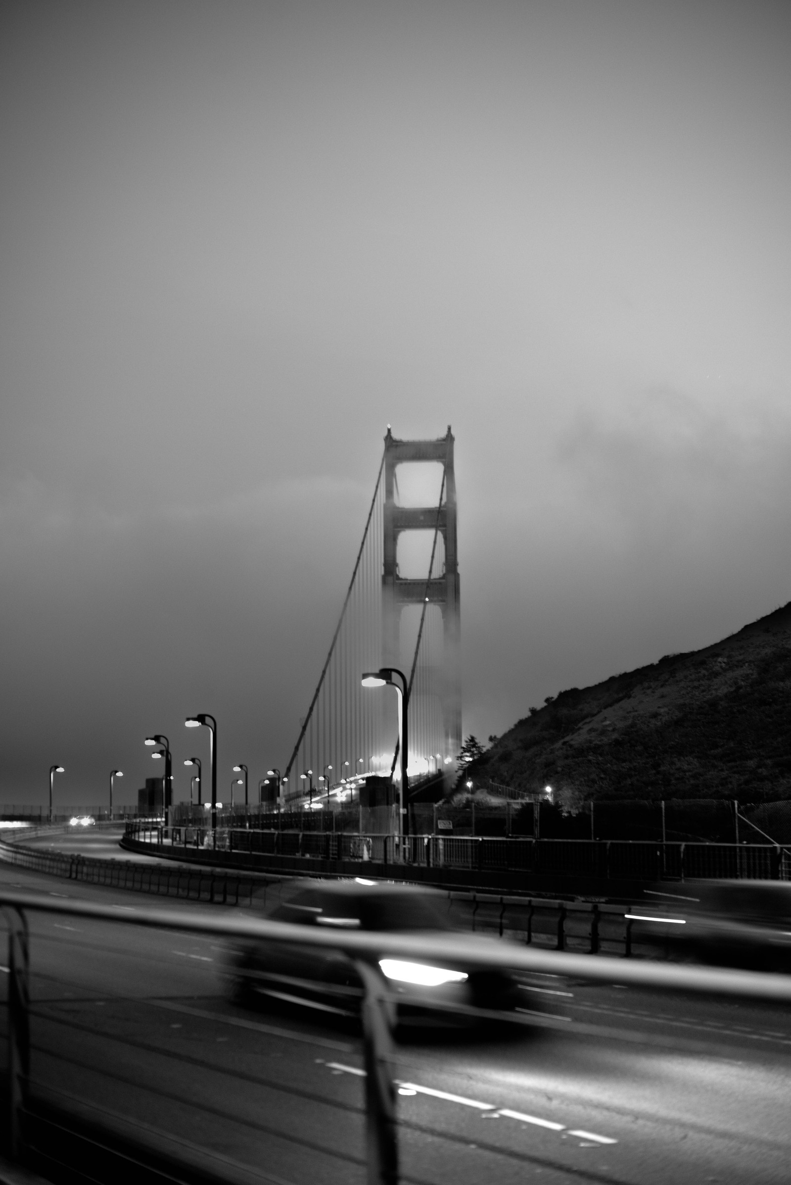 Black and white image of Golden Gate Bridge with fog.