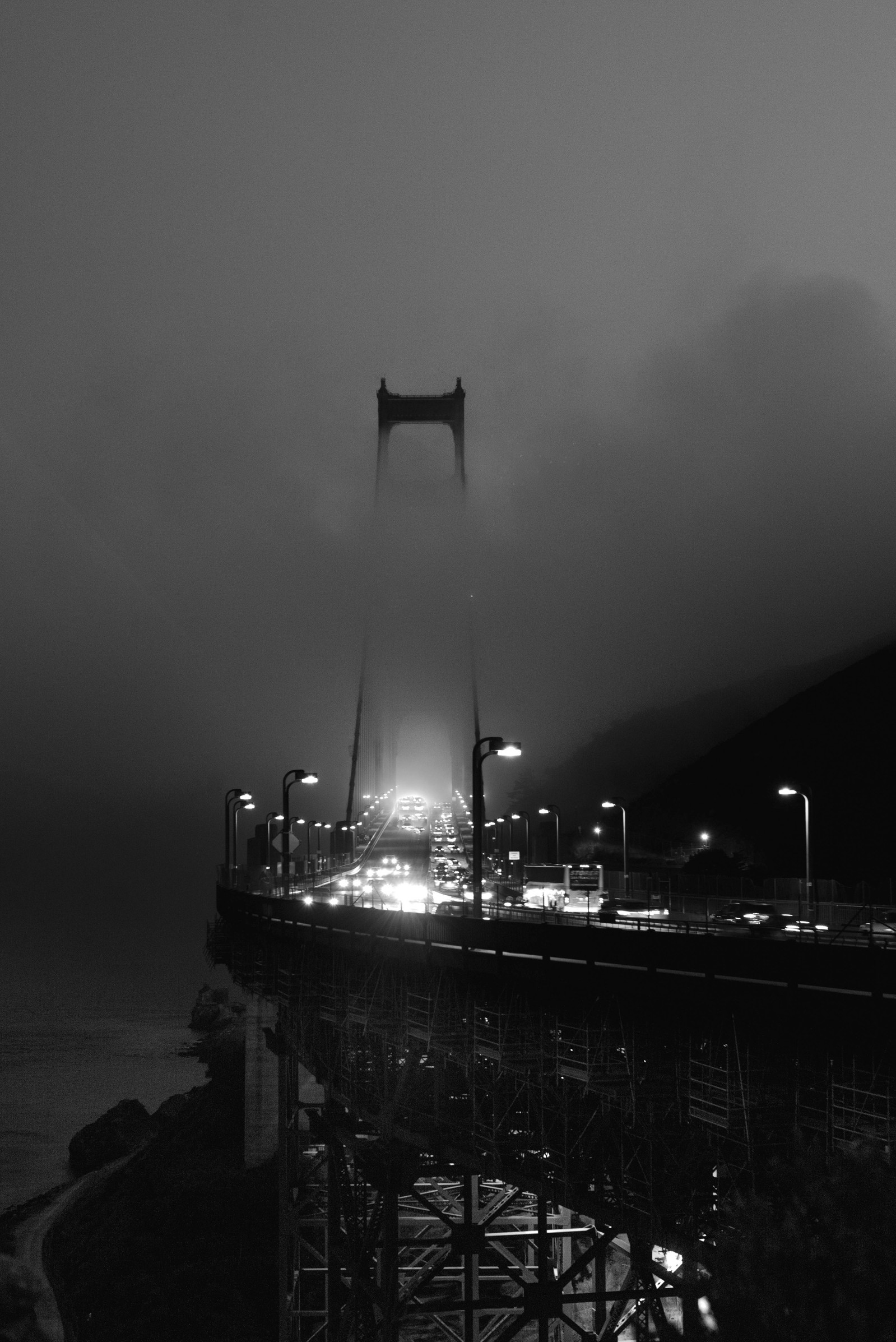 Black and white image of Golden Gate Bridge with fog.