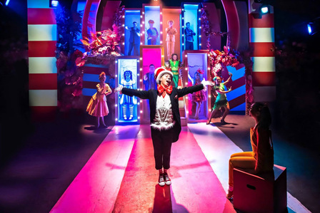Photo by Adam Trigg. Marc Pickering as Cat in the Hat in front of boxes during Seussical at Southwark Playhouse