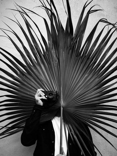 A creative portrait of documentary, travel and street photographer, Alex Crossland, taken by photographer Charlotte Mignot-Hodges