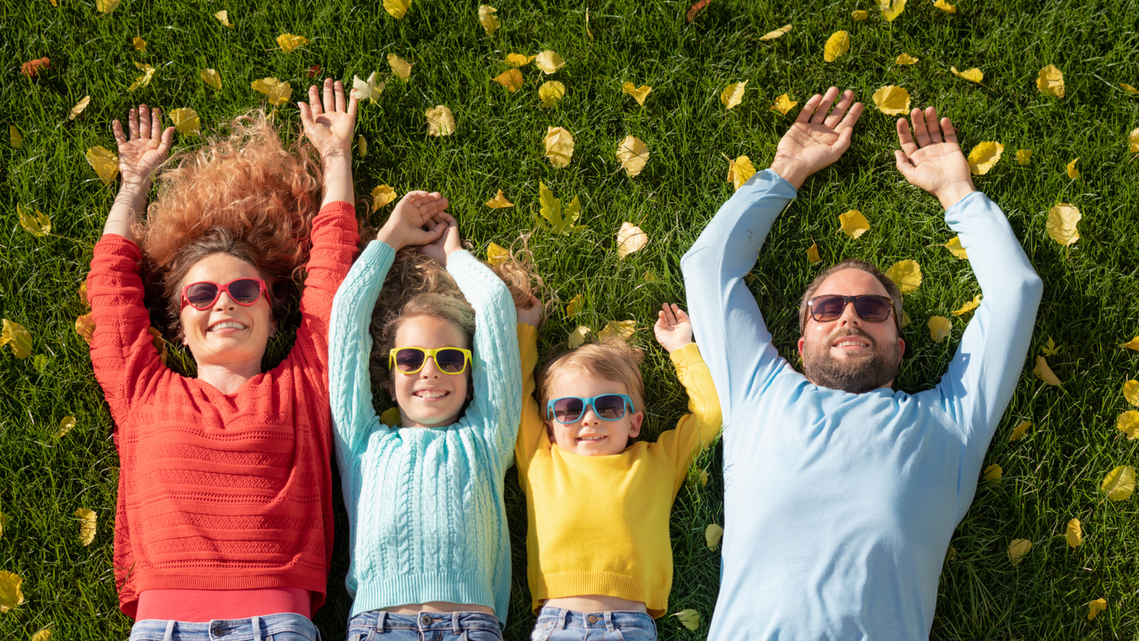 Family shooting session outside, laid down on grass from top angle by Radu Florin