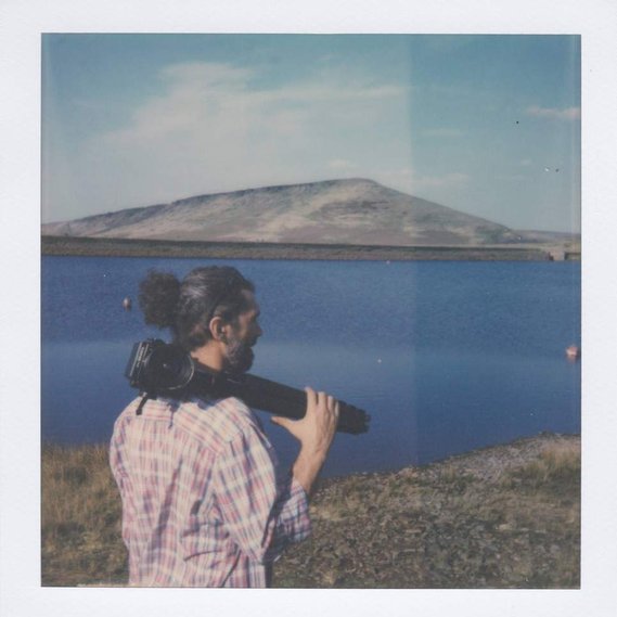 Radu Florin carrying a Bronica GS-1 with a lake in the background