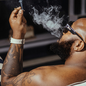 A man smokes at home in Lagos.