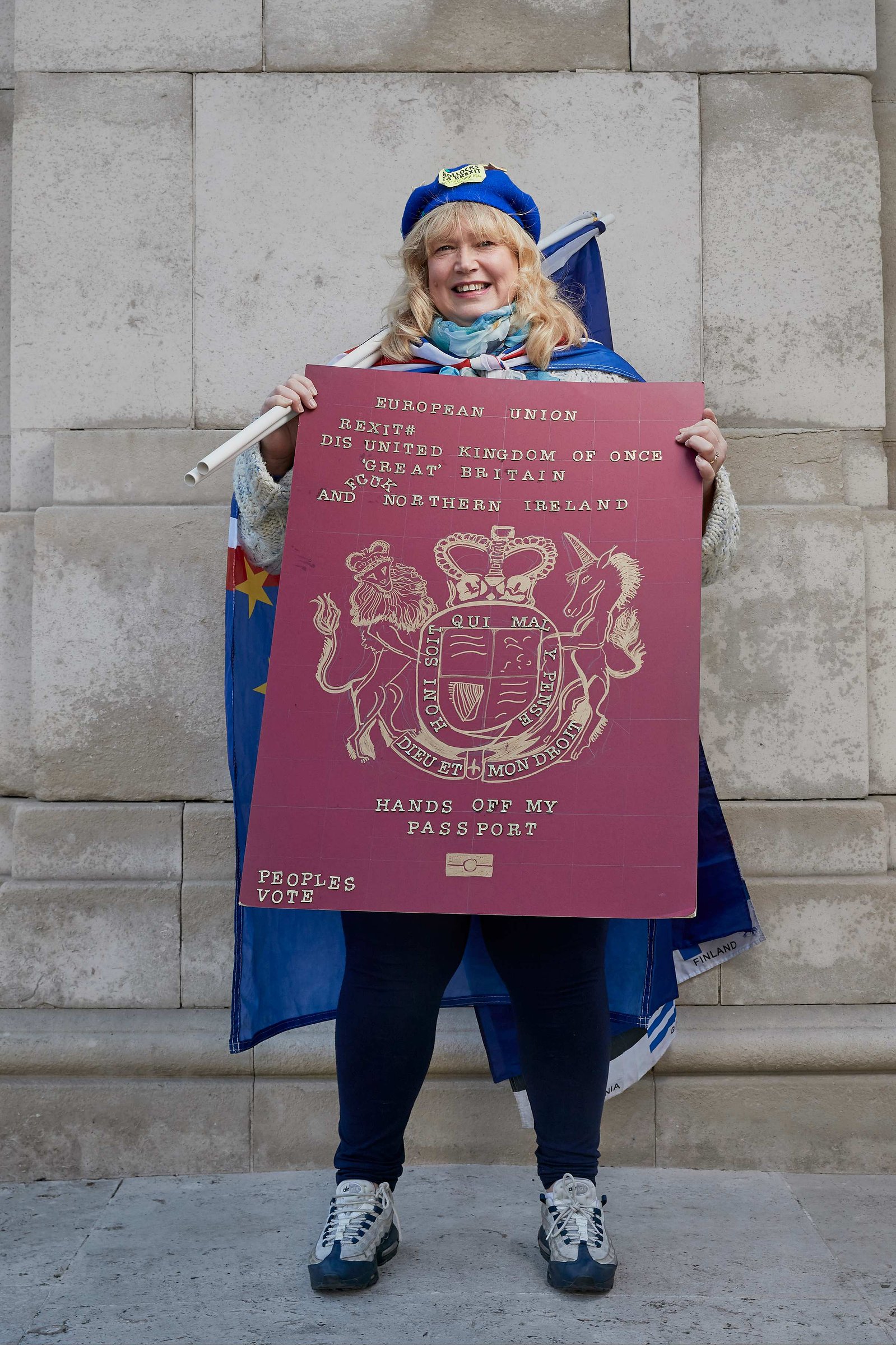 A portrait of Jane Keane, a Remainer, pro European, and anti Brexit protestor photographed holding a giant European passport and flag outside the Houses of Parliament in Westminster, London.