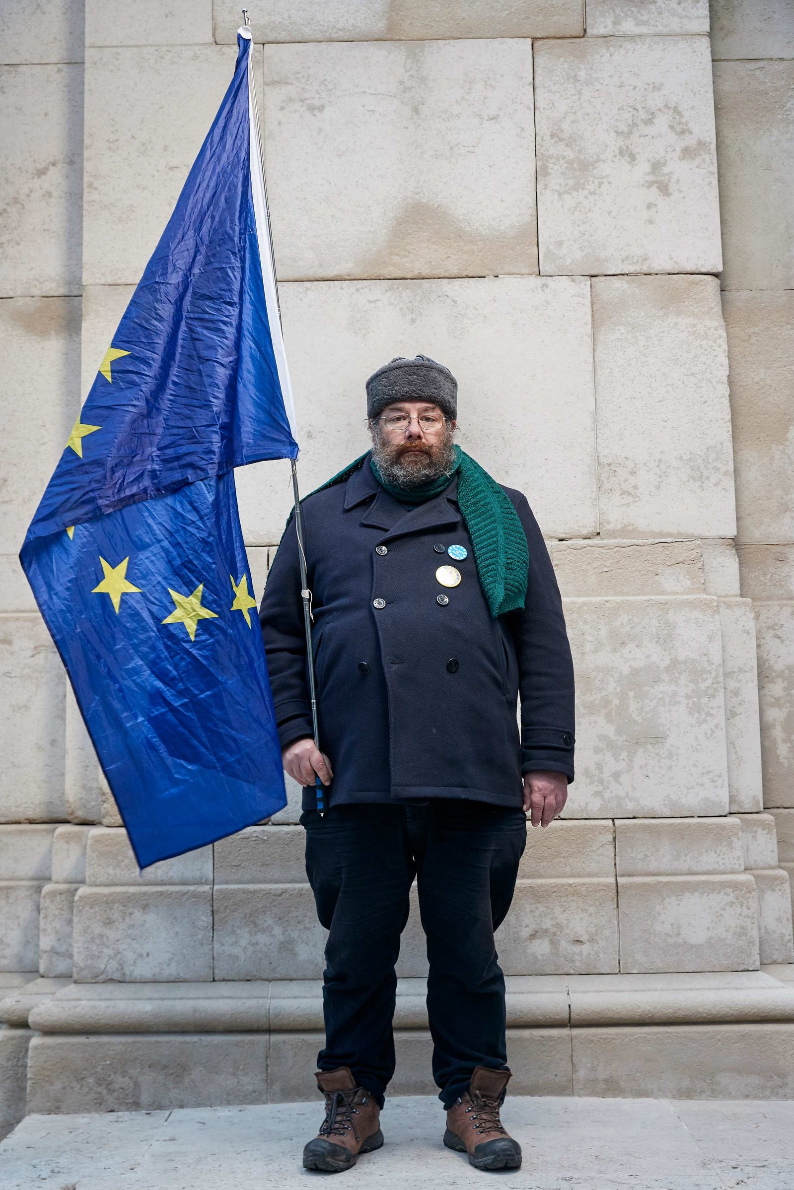 A portrait of Simon Wilks, a Remainer, pro European, and anti Brexit protestor photographed holding a giant European flag outside the Houses of Parliament in Westminster, London.