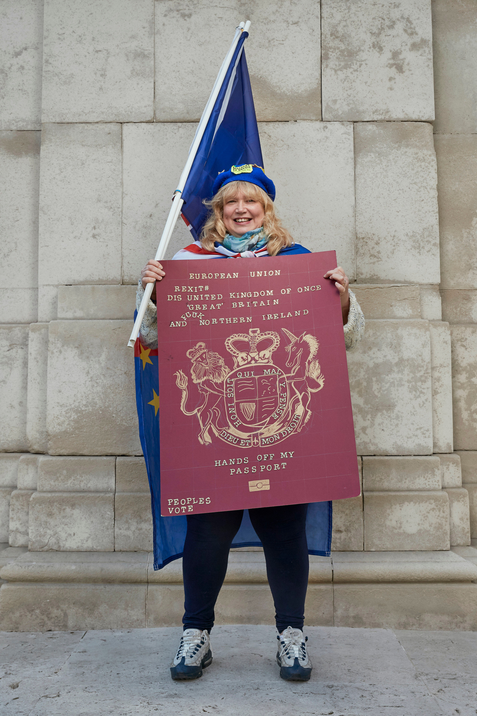 A portrait of Jane Keane, a Remainer, pro European, and anti Brexit protestor photographed holding a giant European passport and flag outside the Houses of Parliament in Westminster, London.