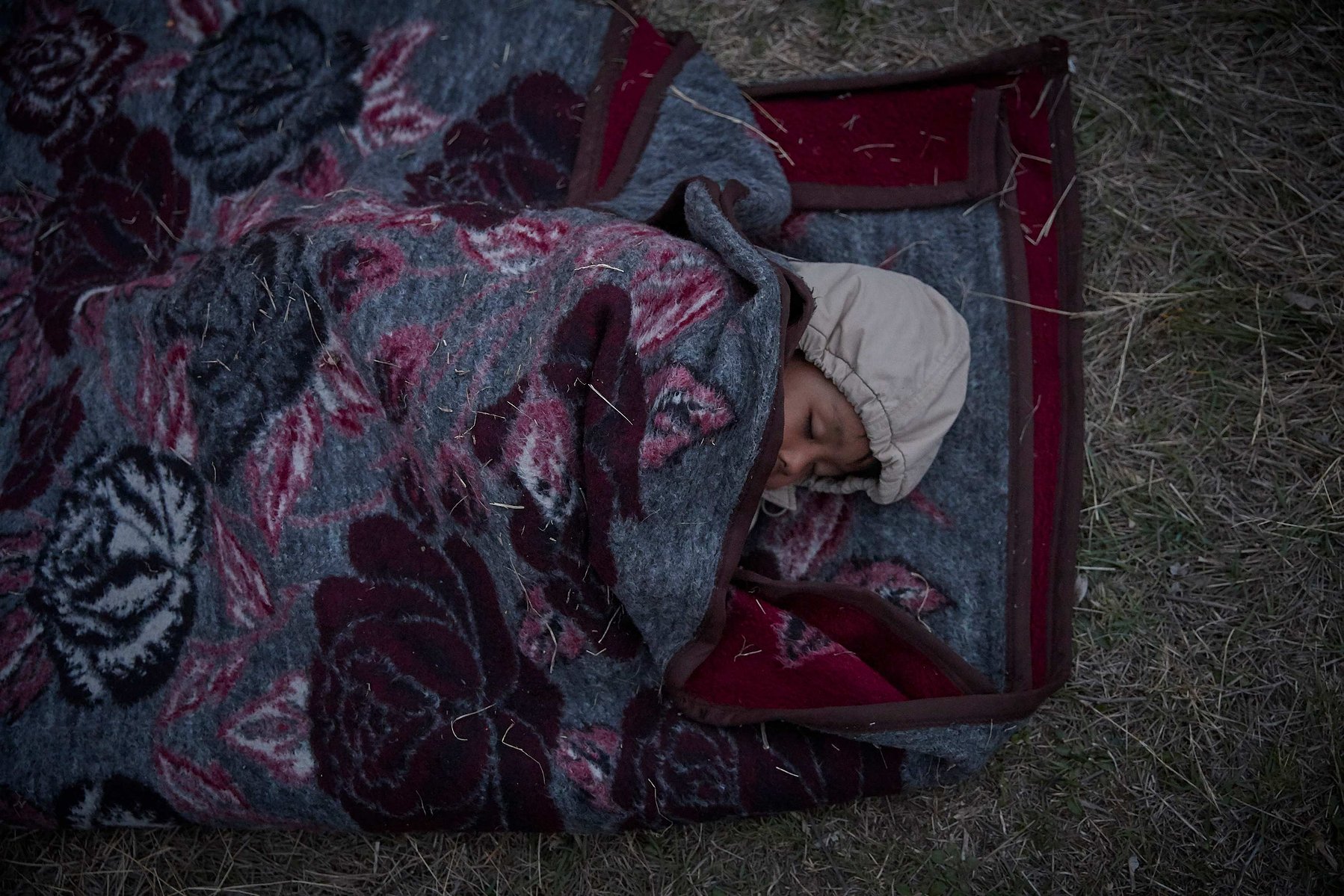 MARCH 5, 2020 - EDIRNE, TURKEY: Elyas, 5, from Afghanistan sleeps in a makeshift refugee camp on the banks of the river in Edirne as his family waits to cross into Greece and the European Union on March 05, 2020 in Edirne, Turkey.