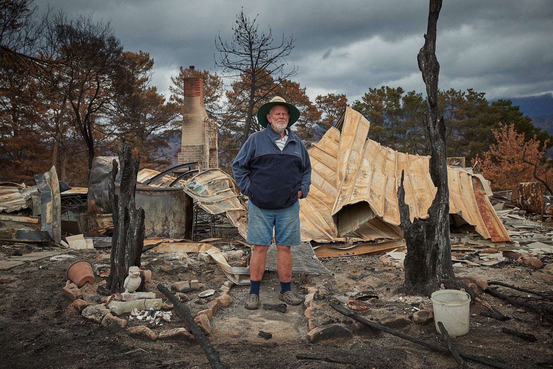 Farmer Kevin Allen, 68, stands by the remains of his house which was destroyed by bushfire on the outskirts of the small town of Cobargo in New South Wales, on 17 January 2019.