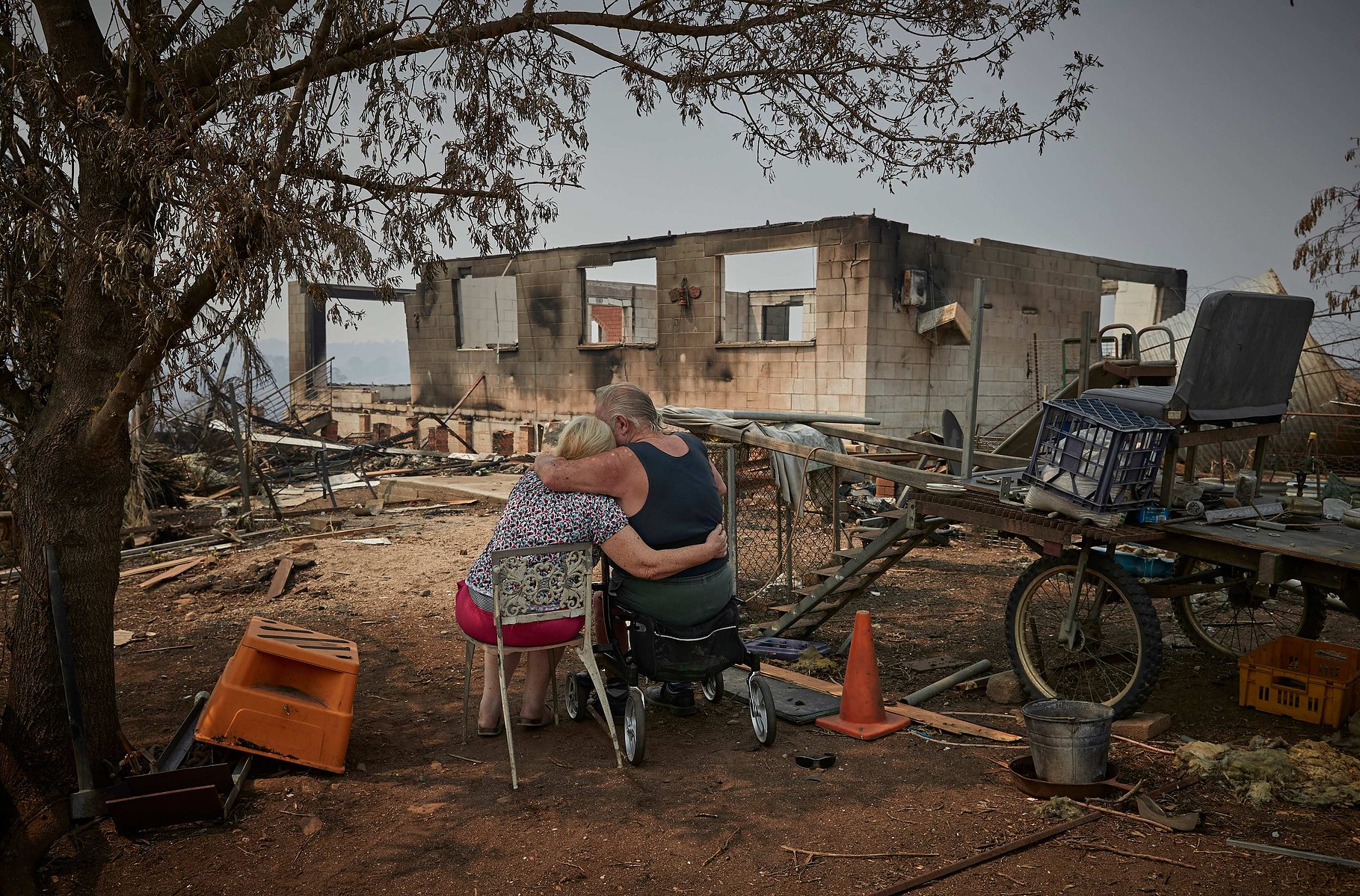 WANDELLA, AUSTRALIA - JANUARY 16, 2020: Ron and Gloria Corby comfort each other after surveying the remains of their house which they built themselves 35 years ago on the outskirts of the small town of Cobargo in New South Wales, on 16 January 2019.
