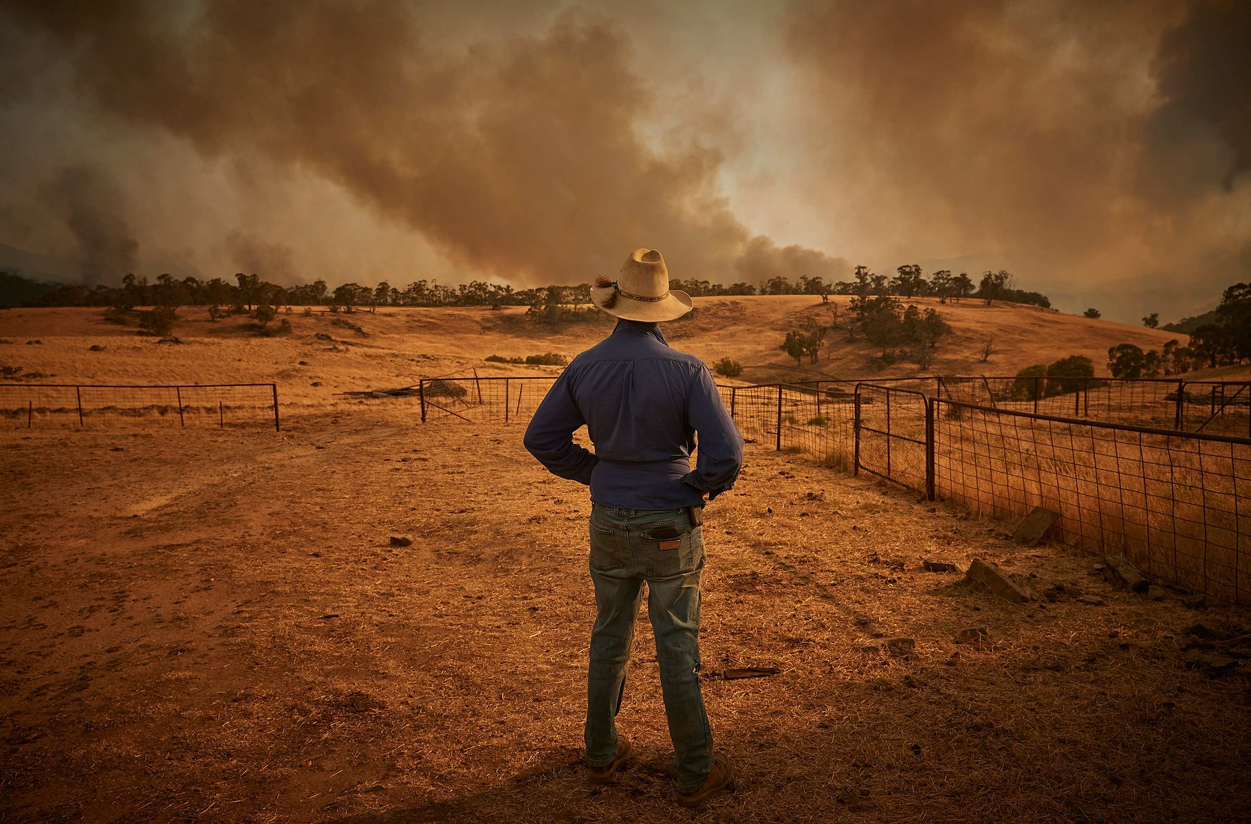 TUMBARUMBA, AUSTRALIA - JANUARY 11, 2020: A farmer watches as the New South Wales 'Mega' fire, which measures 1.5 million acres, approaches the outskirts of the small town of Tumbarumba in the Snowy Mountains, on 11 January 2019.