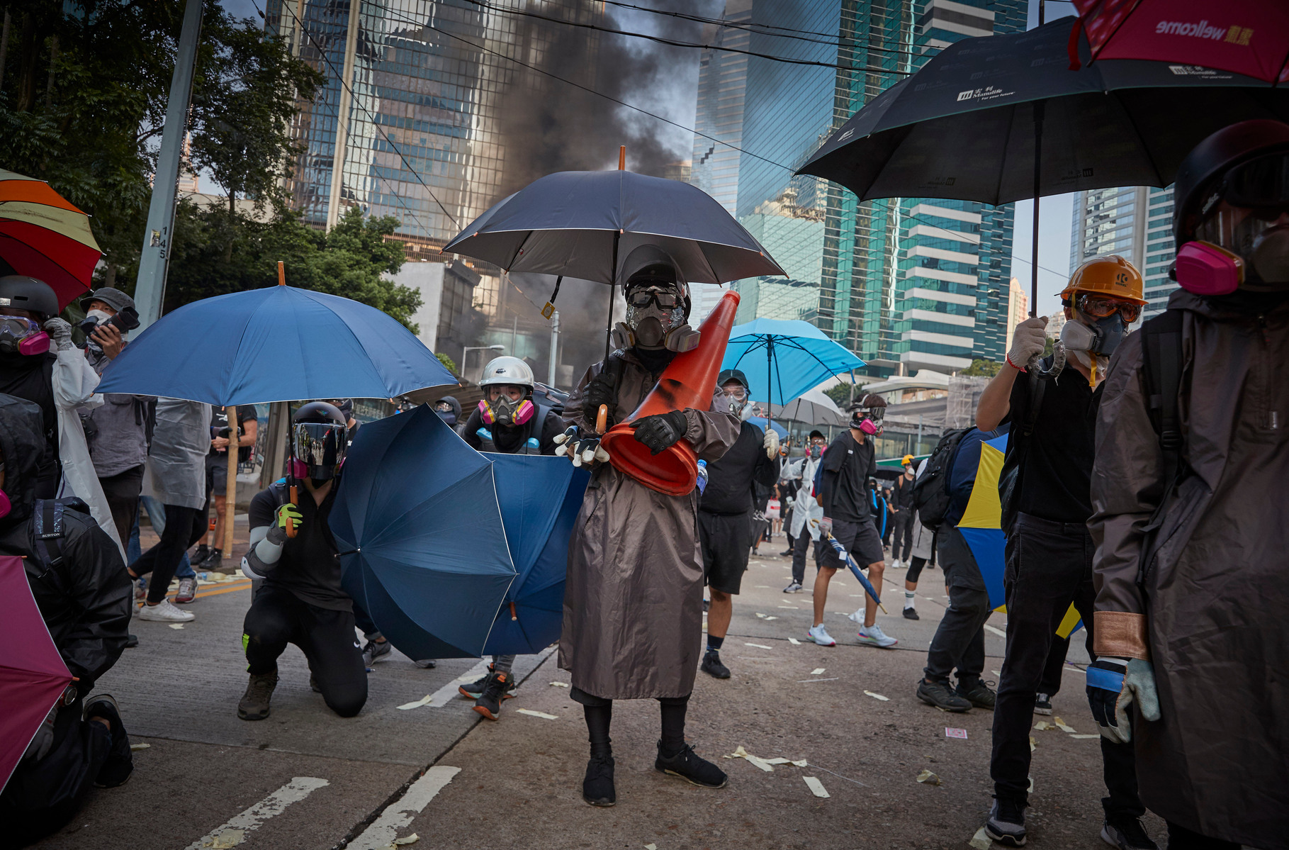 OCTOBER 1: Pro-democracy protestors wearing gas masks and helmets face the police near the Legco Government Buildings in Admiralty as protests to mark the 70th anniversary of the People's Republic of China turn violent.