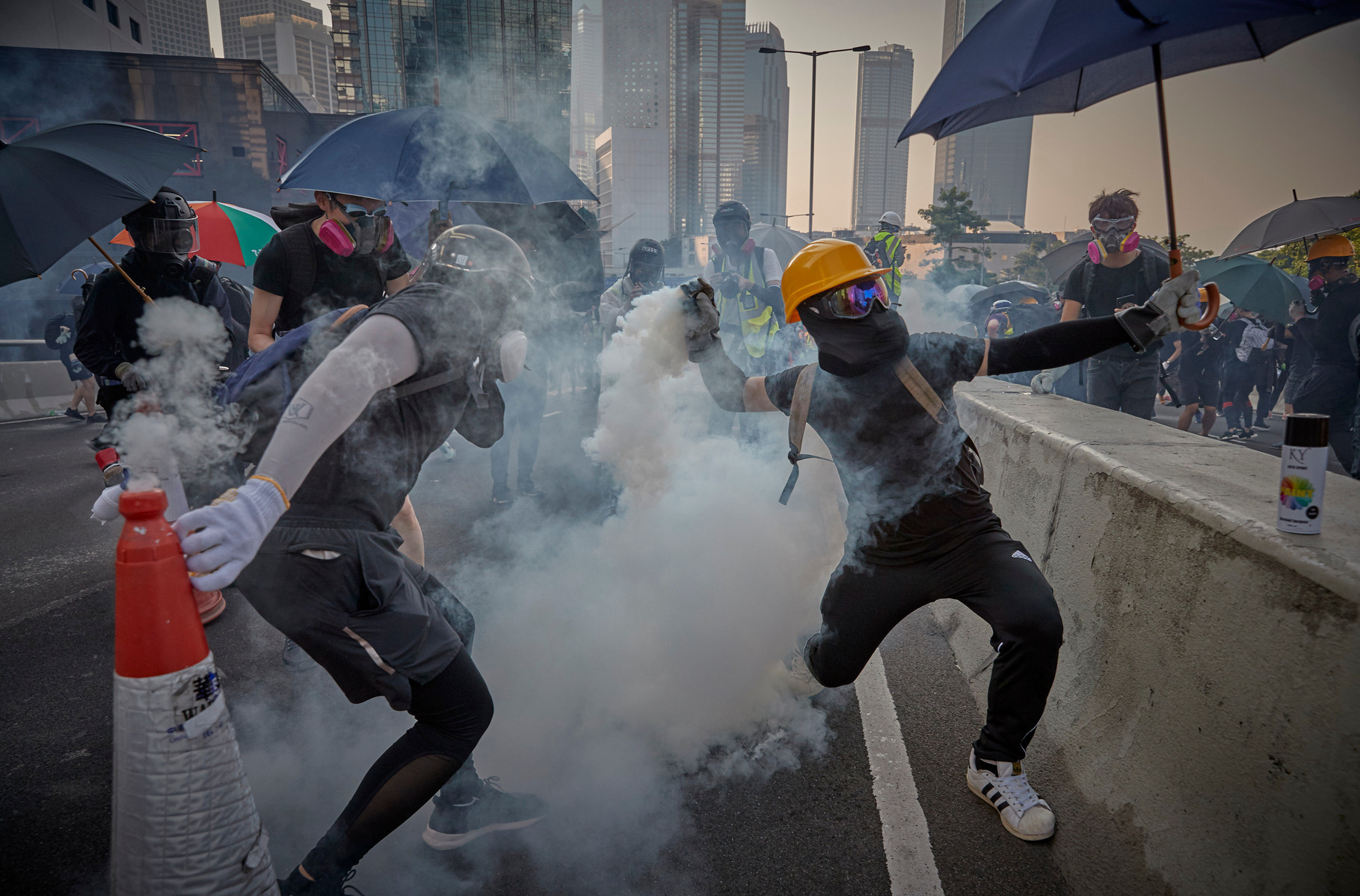 OCTOBER 1: Pro-democracy protestors throw tear gas shells back towards the Police near the Legco Government Buildings in Admiralty as protesters mark the 70th anniversary of the People's Republic of China.