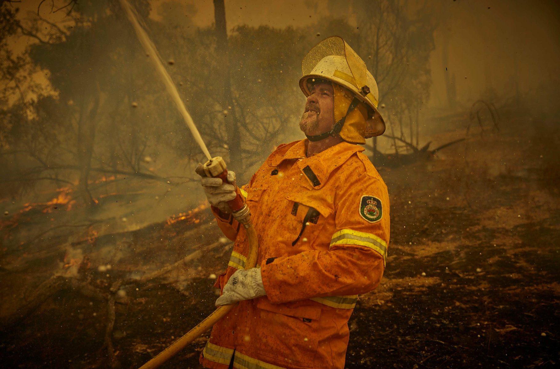 An RSF (Rural Fire Service) volunteer firefighter fights a bushfire on the outskirts of the small town of Tumbarumba in the Snowy Mountains New South Wales.