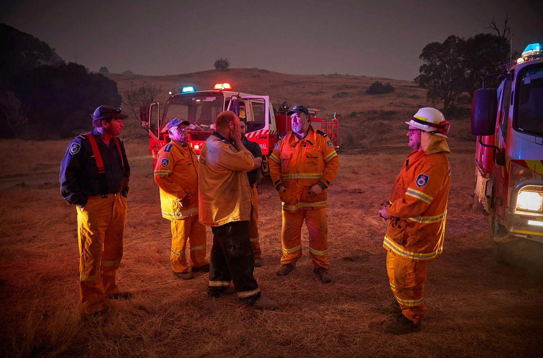 TUMBARUMBA, AUSTRALIA - JANUARY 12, 2020: Rural Fire Service volunteer firefighters discuss how to contain the approaching fire on the outskirts of the small town of Tumbarumba in the Snowy Mountains, on 12 January 2019.