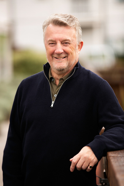 A friendly middle aged man poses for a portrait in Bath, UK.