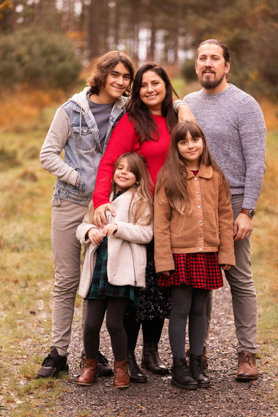 A family of five, including a teenage son and two younger daughters pose for a photo at Moors Valley Country Park in Ringwood