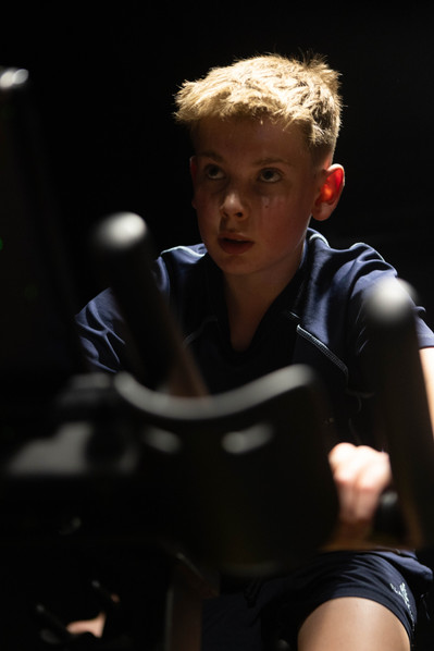 A student at Clayesmore School, Dorset in the spinning room works out in school uniform.