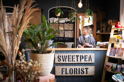 A florist behind the counter of her shop in Blandford, England. 