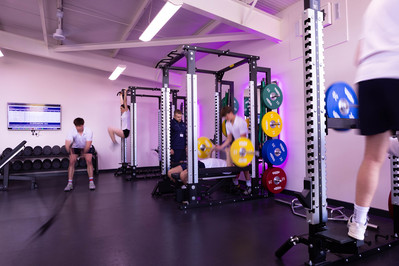 Students work hard in a pink lit gym at Clayesmore School, North Dorset.