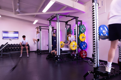 Students work hard in a pink lit gym at Clayesmore School, North Dorset.