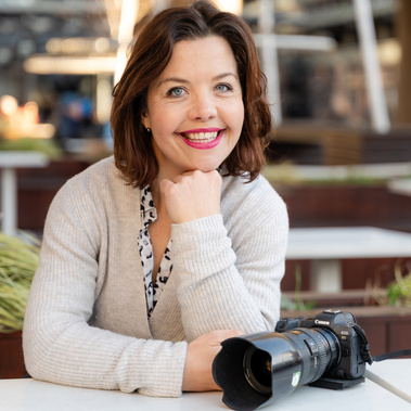 A professional photographer poses with her camera outside in Bournemouth, England.