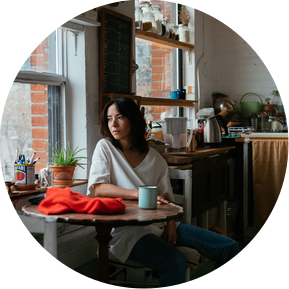 Unposed portrait of the poet looking out the window enjoying coffe in her Toronto Loft
