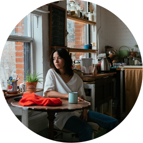 Unposed portrait of the poet looking out the window enjoying coffe in her Toronto Loft