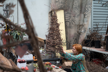 artist and craftswoman  Gosia Bernatt in her studio making, dwarfed by her creations, making  handmade timeless pieces out of vines