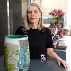 Portrait of Anne Clifton of Glass Manifesto in the Glass Gallery and Studio.  Pictured with her glasswork Vetrograph in the foreground. 