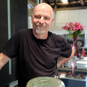 Portrait of Peter Bowles of Glass Manifesto in the Glass Gallery and Studio.  Pictured with his Murrine Quadrant glasswork in the foreground. 