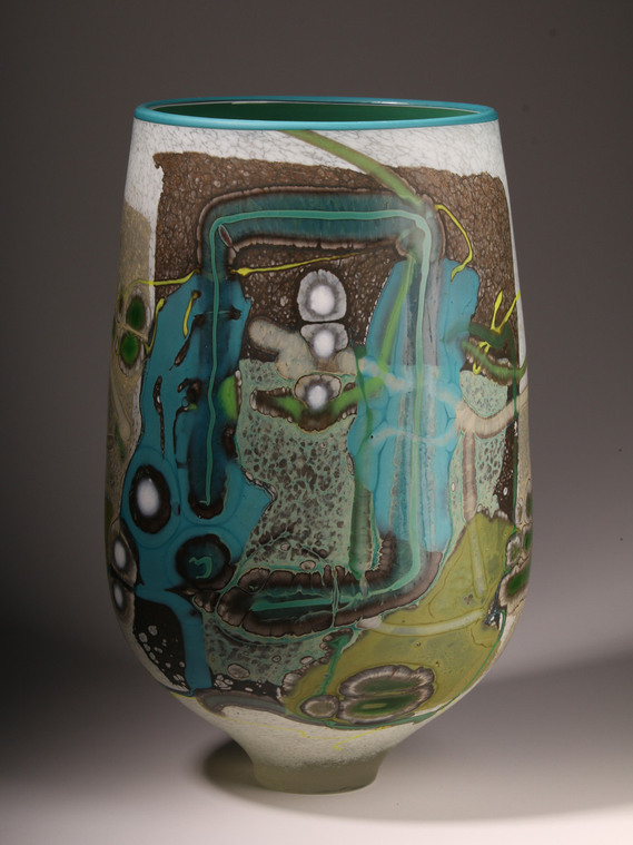 Vetrograph by Anne Clifton.  A tall open handblown glass vessel with an acid etched finish of flameworked glass in an abstract pattern. 