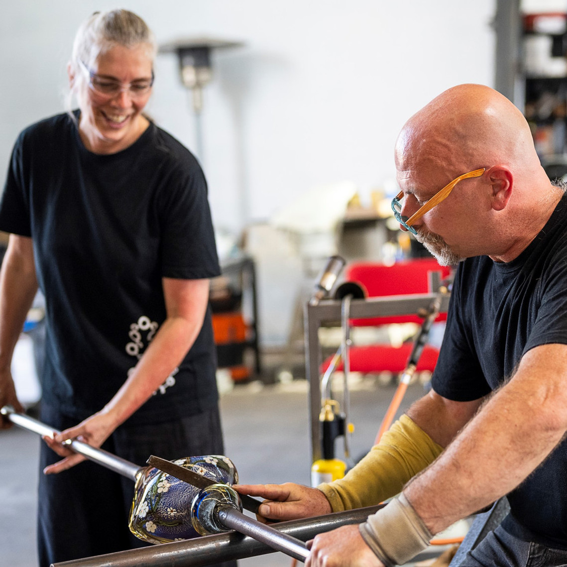Anne Clifton and Peter Bowles of Glass Manifesto hand blowing a Wildflower Perfume Bottle in their Launceston based Glass Studio and Gallery. 