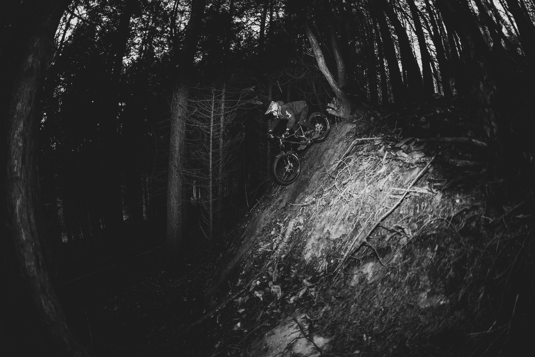 Red Bull Illume 2023 Semi-Finalist selected image in the emerging category. A self shot image of myself mountain biking in the depths of the woods down one of the gnarlier slabs. Using a remote trigger and flash I was able to capture the image.