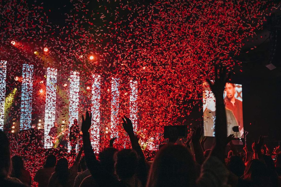 Fans raise their hands as confetti falls at a MercyMe concert in El Paso, Texas.