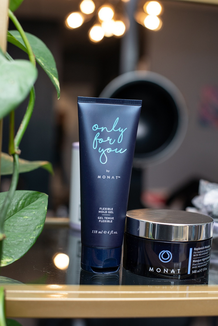 close up image of a hair product for sale sitting on a glass shelf with green plants in foreground at a branding session at Vibe Beauty Bar in Tuttle, Oklahoma