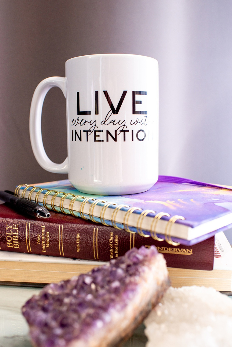 details shot of a coffee mug with a motivational quote, a journal, a Bible and purple crystals at a branding session at Vibe Beauty Bar in Tuttle, Oklahoma