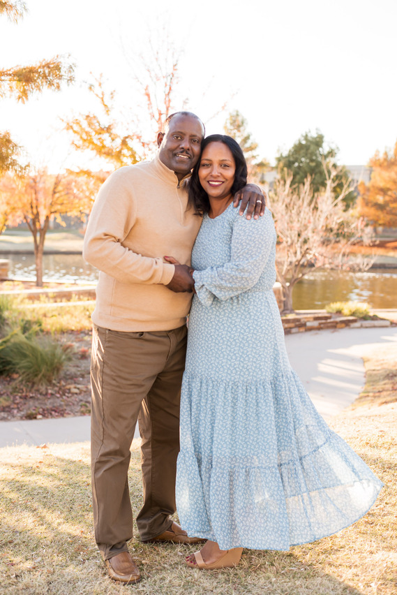 Ethiopian couple stand and hug together in front of the Oklahoma River near Bricktown in Oklahoma City