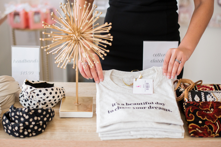 a small business owner places her items for sale on display at a branding photo session in Oklahoma City