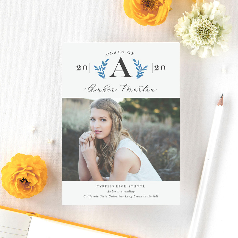photo of a custom senior photo graduation announcement card with a white background and yellow flowers surrounding it