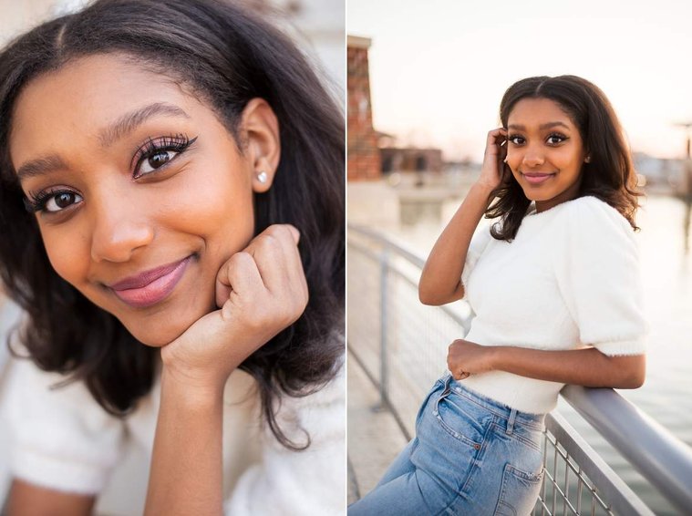 African-American teenage girl in a white sweater close up portrait and she stands along a waters edge at a cap and gown senior photo shoot in Norman Oklahoma