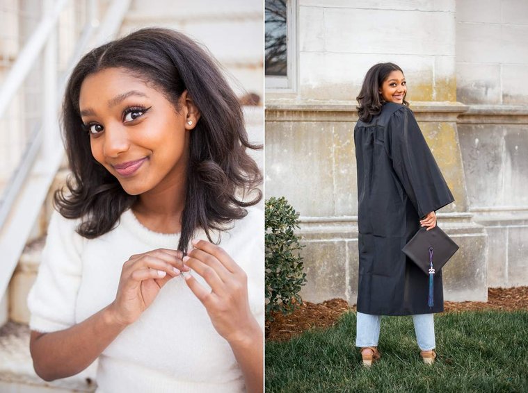 African-American teenage girl sits and smiles and looks over her shoulder in her cap and gown at a senior photo shoot in Norman Oklahoma