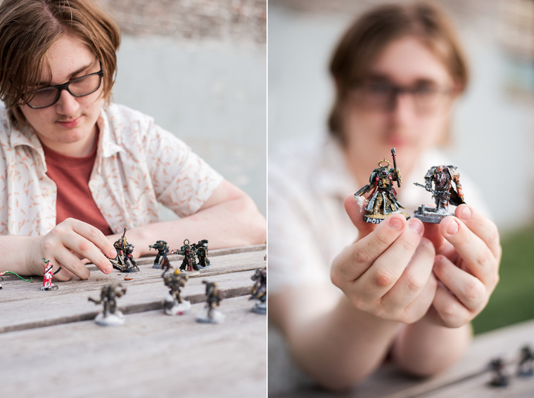senior boy sits at a table with warhammer game pieces in front of him, detailed shot of game pieces in midtown Oklahoma City
