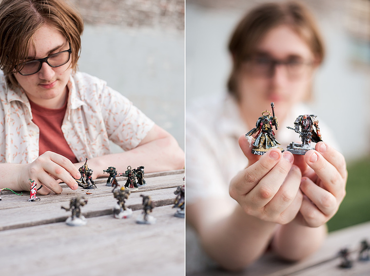 senior boy sits at a table with warhammer game pieces in front of him, detailed shot of game pieces in midtown Oklahoma City