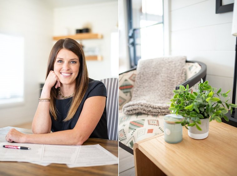 Brand photo shoot of realtor in OKC. She sits at a desk with closing papers in front of her and smiles. Detailed photo showing comforts of home with chair, throw blanket and candle.