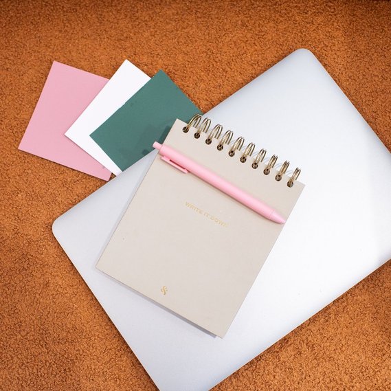 square close up branding photo of a laptop, color swatches and notebook for a graphic design team branding session in OKC